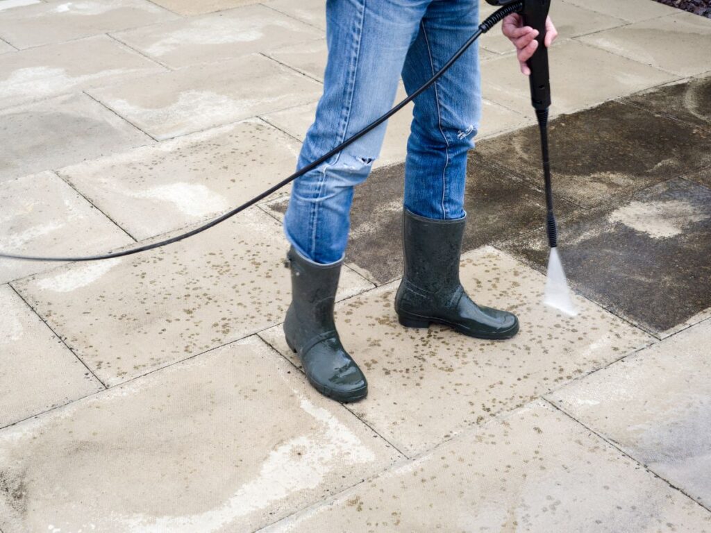 Concrete Cleaning Services in Bridgewater, MA: Driveways, Patios & Pool Decks 1 Person cleaning patio tiles with pressure washer.